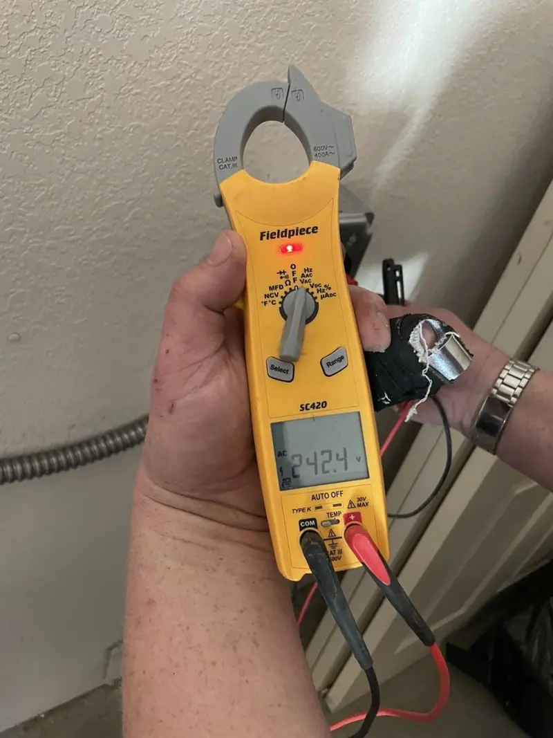 Voltage testing with clamp meter during Circuit Breaker Repair in Colleyville